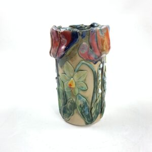 Zylindrische Vase  mit verschiedenen Blumen drumherum